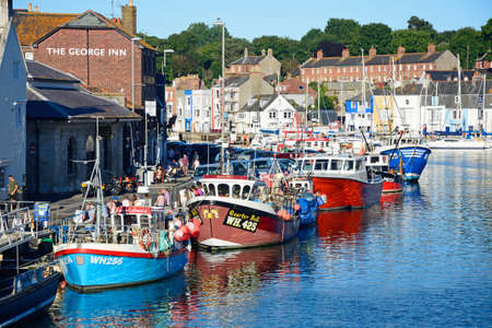 Elevated view of the fishing trawlers in the harbour and quayside buildings, Weymouth, Dorset, England, UK, Western Europe.のeditorial素材
