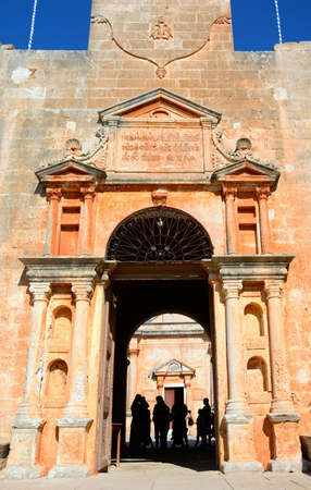 Tourists standing in the entrance to the Agia Triada monastery, Agia, Crete, Greece, Europe.のeditorial素材