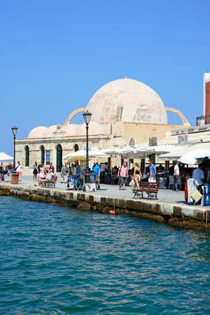 View of the inner harbour looking towards the mosque and waterfront restaurants, Chania, Crete, Greece, Europe.のeditorial素材