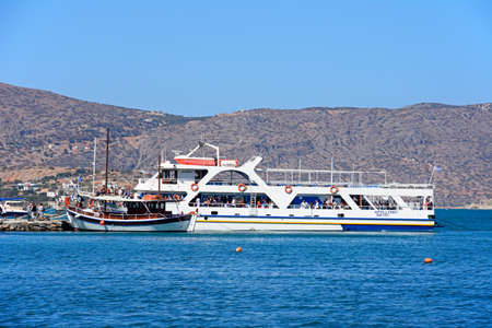Tourists on tour boats in the harbour, Elounda, Crete, Greece, Europe.のeditorial素材