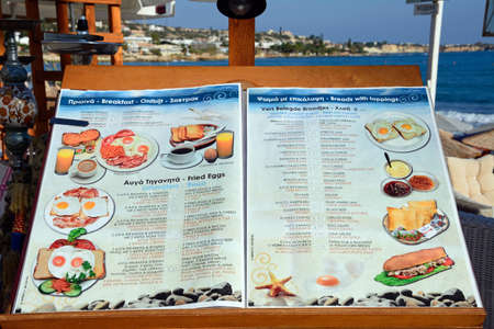 Breakfast menu outside a restaurant along the waterfront, Hersonissos, Crete, Greece, Europe.のeditorial素材