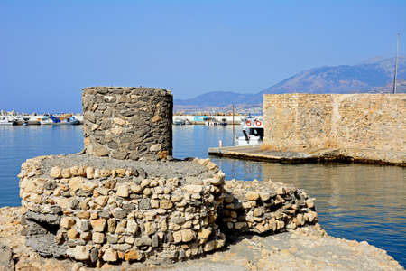 View of the Kales Venetian fortress at the entrance to the harbour with an old tower in the foreground, Ierapetra, Crete, Greece, Europe.のeditorial素材