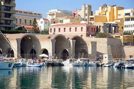 Fishing boats moored in the harbour with dockyard buildings to the rear, Heraklion, Crete, Greece, Europe.のeditorial素材