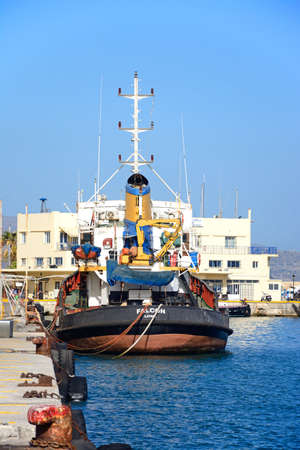 Tug boat moored in the harbour with the coastguard office to the rear, Heraklion, Crete, Greece, Europe.のeditorial素材