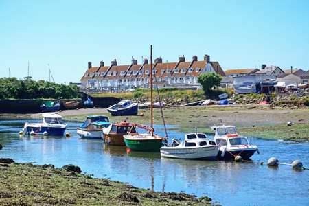 Fishing boats moored along the River Axe, Axmouth, Devon, England, UK, Western Europe.
