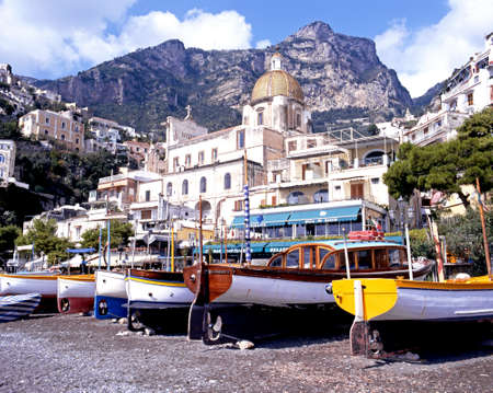 Traditional boats on the beach with town buildings and church to the rear, Positano, Amalfi Coast, Italy, Europe.のeditorial素材