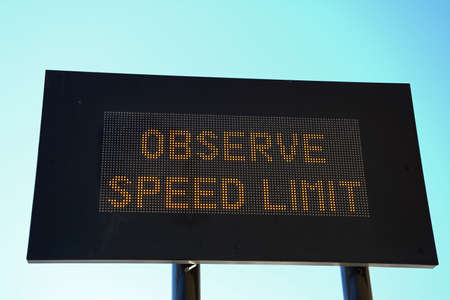 LED Observe speed limit sign with a black border against a blue sky, Valletta, Malta, Europe.の写真素材