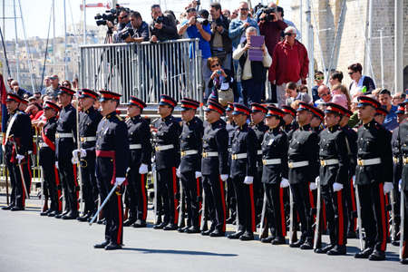 Freedom day celebrations with military personnel standing in a line by the Freedom Day monument and...