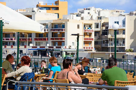 Tourists relaxing at a pavement cafe during the Springtime, Bugibba, Malta, Europe.のeditorial素材