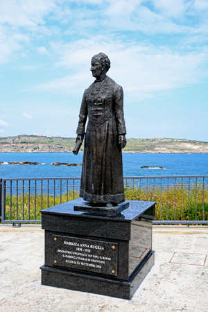 Statue of Markiza Anna Bugeja on the waterfront with views across St Pauls Bay, Bugibba, Malta, Europe.のeditorial素材