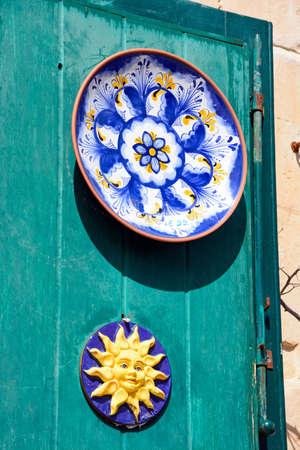 Traditional Maltese plates on a green door in the old town, Mdina, Malta, Europe.のeditorial素材