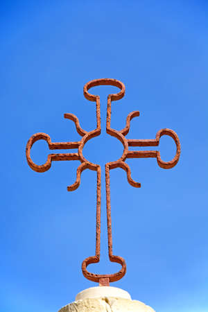 Decorative old wrought iron cross against a blue sky, Mdina, Malta, Europe.の写真素材