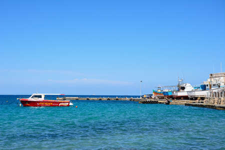 Small tour boat moored in the harbour, Mellieha, Malta, Europe.のeditorial素材