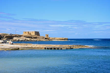 View along the rugged coastline towards the Il-Qolla I-Badja battery, Redoubt, Marsalforn, Gozo, Malta, Europe.のeditorial素材