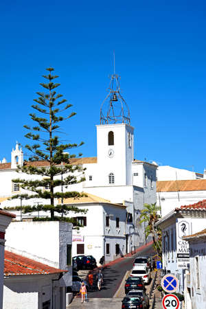 Elevated view of an old town shopping street with a church to the rear, Albufeira, Algarve, Portugal, Europe.のeditorial素材