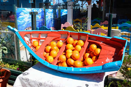 Wooden boat full of oranges at a waterfront restaurant, Alvor, Algarve, Portugal, Europe.のeditorial素材