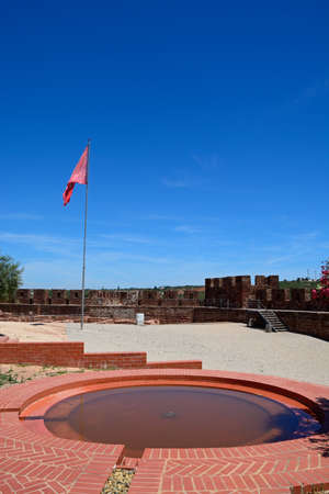 Courtyard and gardens of the Medieval castle with battlements and tower to the rear, Silves, Portugal, Europe.のeditorial素材