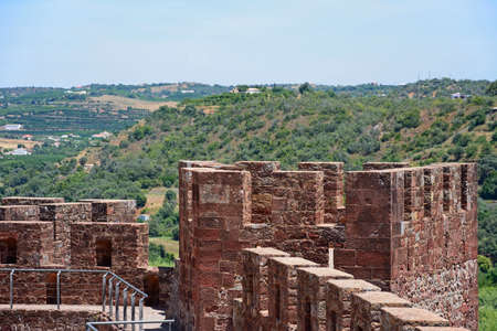 Medieval battlements and one of the towers inside the castle with views across the countryside, Silves, Portugal, Europe.の写真素材