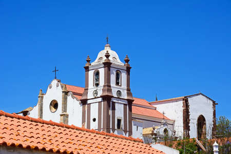 View of the Gothic cathedral (Igreja da Misericordia) and bell tower seen over rooftops, Silves, Portugal, Europe.の写真素材