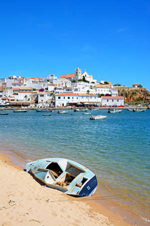 View of the white town with boats moored on the river Arade, Ferragudo, Algarve, Portugal, Europe.のeditorial素材