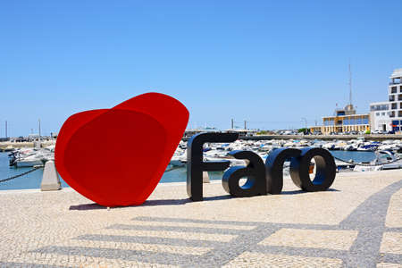 Faro sign and heart along the waterfront with boats moored in the marina to the rear, Faro, Algarve, Portugal, Europe.のeditorial素材