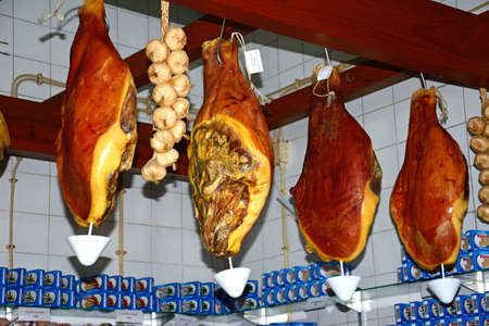 Cured legs of ham for sale in the indoor market, Olhau, Algarve, Portugal, Europe.