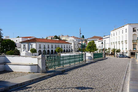 View across the Roman bridge with town buildings to the rear, Tavira, Algarve, Portugal, Europe.