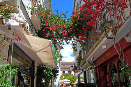 MARBELLA, SPAIN - MAY 26, 2008 - Narrow shopping alleyway leading to Orange Square in the old town with bougainvillea hanging from the balconies, Marbella, Malaga Province, Andalusia, Spain, Europe, May 26, 2008.のeditorial素材