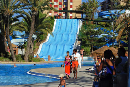 Water slide and pool in the water park with tourists enjoying the setting, Fuengirola, Malaga Province, Andalusia, Spain, Western Europe.のeditorial素材