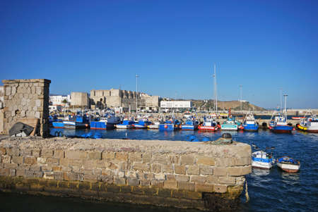 TARIFA, SPAIN - SEPTEMBER 14, 2008 - View of traditional Spanish fishing trawlers in the harbour with Tarifa castle to the rear, Tarifa, Cadiz Province, Andalusia, Spain, Europe, September 14, 2008.のeditorial素材