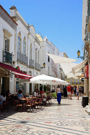 View along the R de Santo Antonio lined with restaurants and shops in the city centre, Faro,...