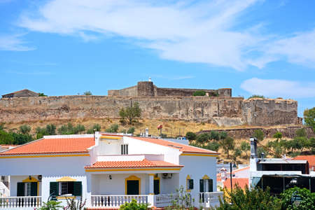 View of the medieval castle with town buildings in the foreground, Castro Marim, Algarve, Portugal, Europe.のeditorial素材