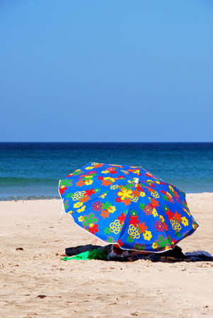 ZAHARA DE LOS ATUNES, SPAIN - SEPTEMBER 14, 2008 - Tourists relaxing under a parasol on the beach, Zahara de los Atunes, Cadiz Province, Andalusia, Spain, Europe, September 14, 2008.のeditorial素材