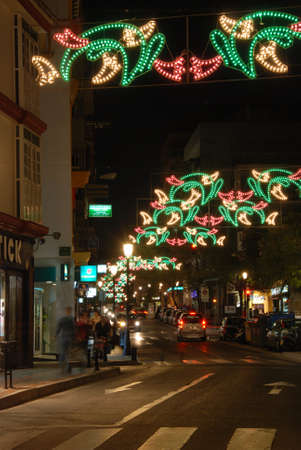 Christmas decorations along a town centre street at night, Fuengirola, Costa del Sol, Malaga Province, Andalucia, Spain.のeditorial素材
