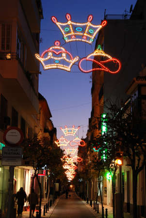 Christmas decorations along a town centre street at night, Fuengirola, Costa del Sol, Malaga Province, Andalucia, Spain.のeditorial素材