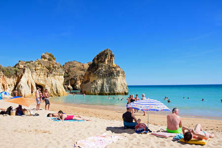Tourists relaxing on the beach and in the sea, Praia da Rocha, Portimao, Algarve, Portugal, Europe.のeditorial素材