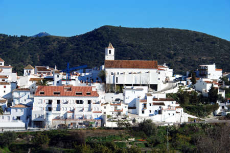 View of whitewashed village (pueblo blanco) with mountains to the rear, Sedella, Spain.のeditorial素材
