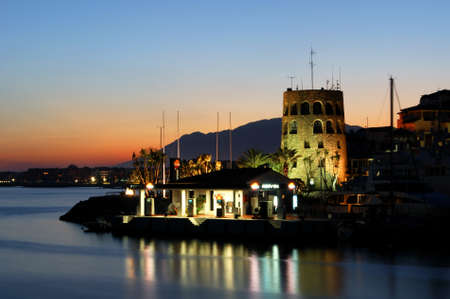 Puerto Banus harbour mouth and watchtower at sunset, Marbella, Spain.のeditorial素材
