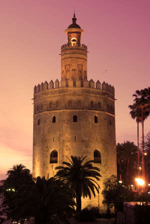 View of the Tower of Gold (Torre del Oro) illuminated at sunset, Seville, Spain.のeditorial素材