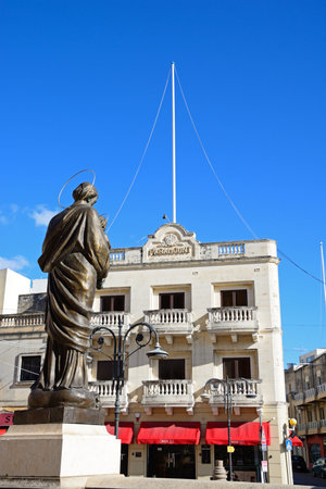 MOSTA, MALTA - APRIL 02, 2017 - Statue in front of the Mosta Dome with the old Paramount cinema buildings to the rear around Rotunda Square in the town centre, April 02, 2017.のeditorial素材