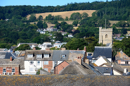 SIDMOUTH, UK - AUGUST 08, 2022 - Elevated view over the town rooftops with the Devon countryside to the rear, Sidmouth, Devon, UK, Europe, August 08, 2022.のeditorial素材