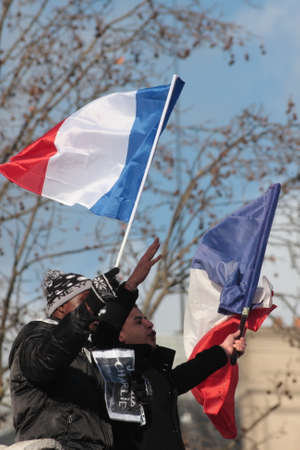 Black people waving french flag during manifestation on Republic Square in Paris against terrorism and in memory of the attack against satirical newspaper Charlie Hebdo-January 11, 2015. Franceのeditorial素材