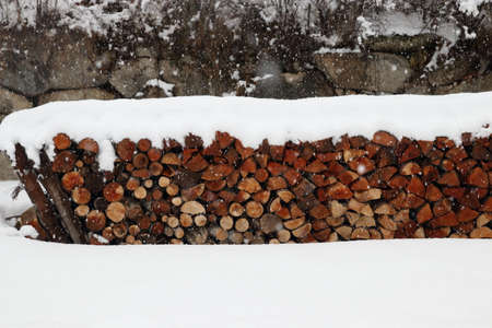 Pile of logs in winter for heatingの写真素材