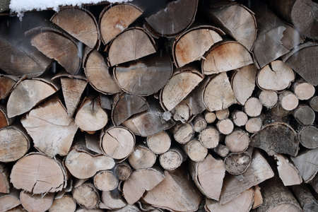 Pile of logs in winter for heating