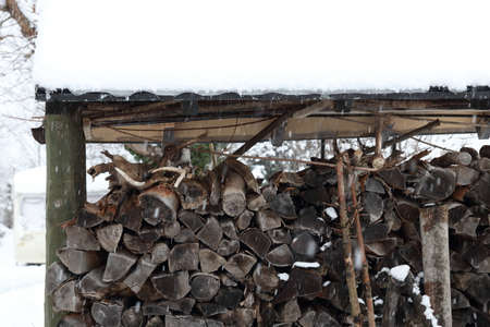 Pile of logs in winter for heating
