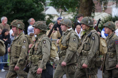 Parade of people disguised as US soldiers of the Second World War for the national holiday of 14...