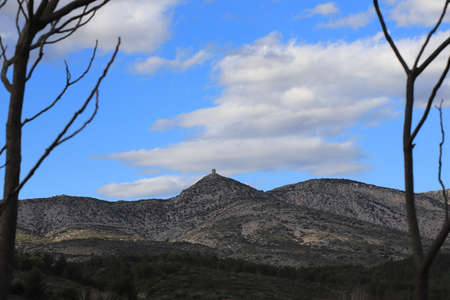 Perched and isolated tower on arid and Mediterranean hillsの写真素材