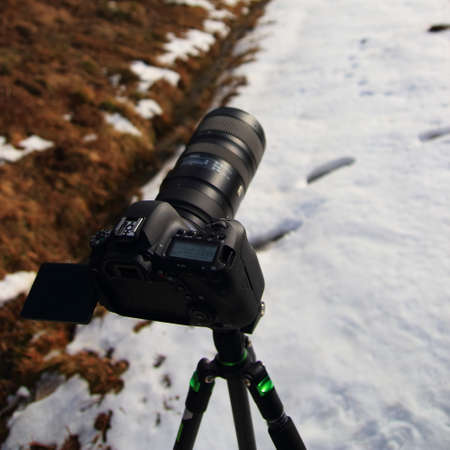 SLR camera on a tripod taking picturesの写真素材