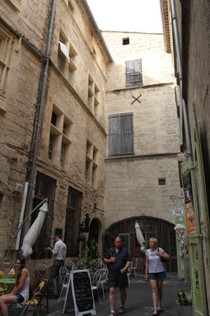 Tourists people walking in the street of touristic city of Pezenas, Herault in southern of Franceのeditorial素材