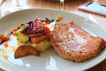 plate of tuna steak and its vegetable garnish in a french restaurantの写真素材